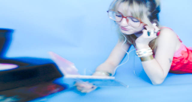 model posing with CD player with blue background