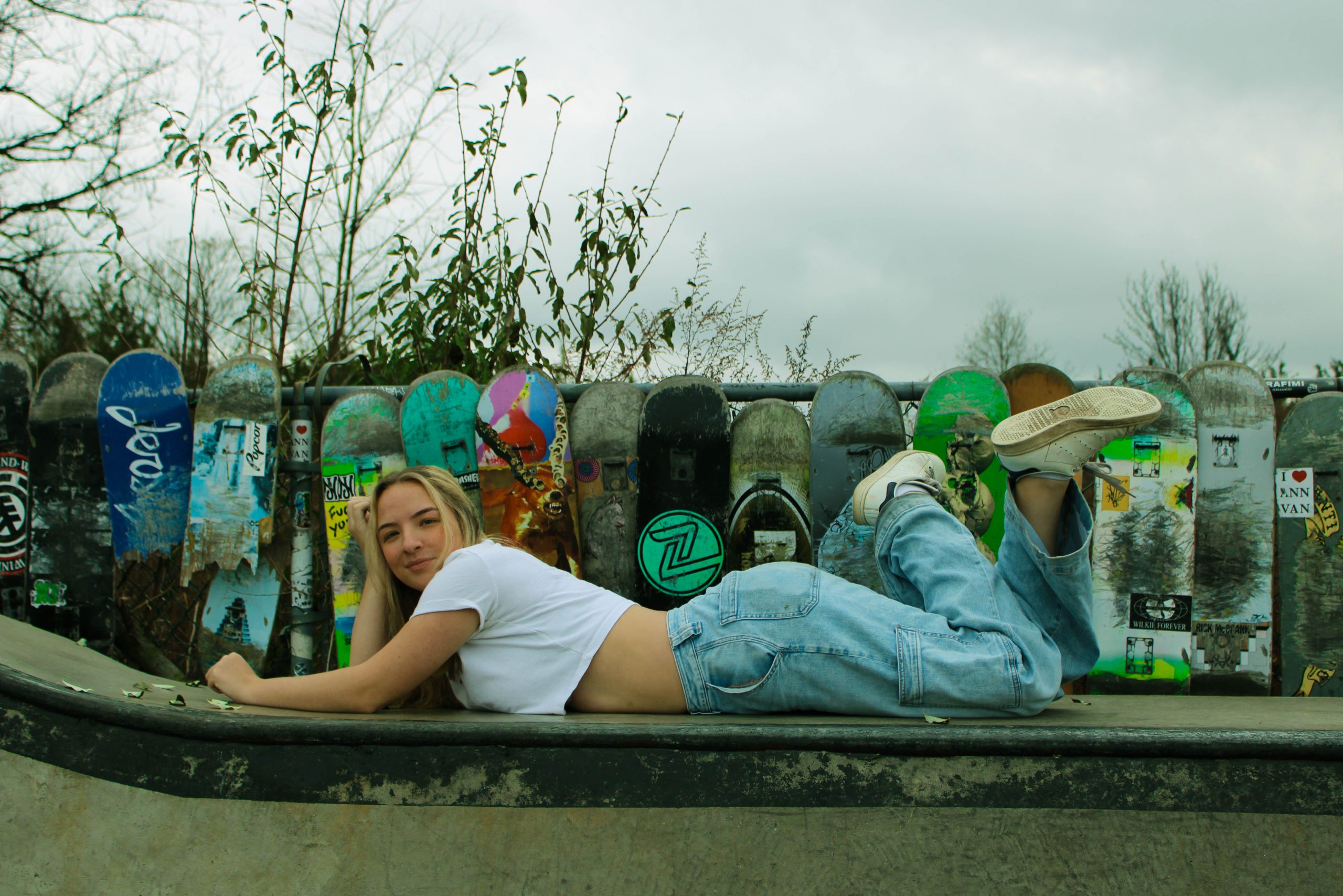 model posing in front of skateboard wall