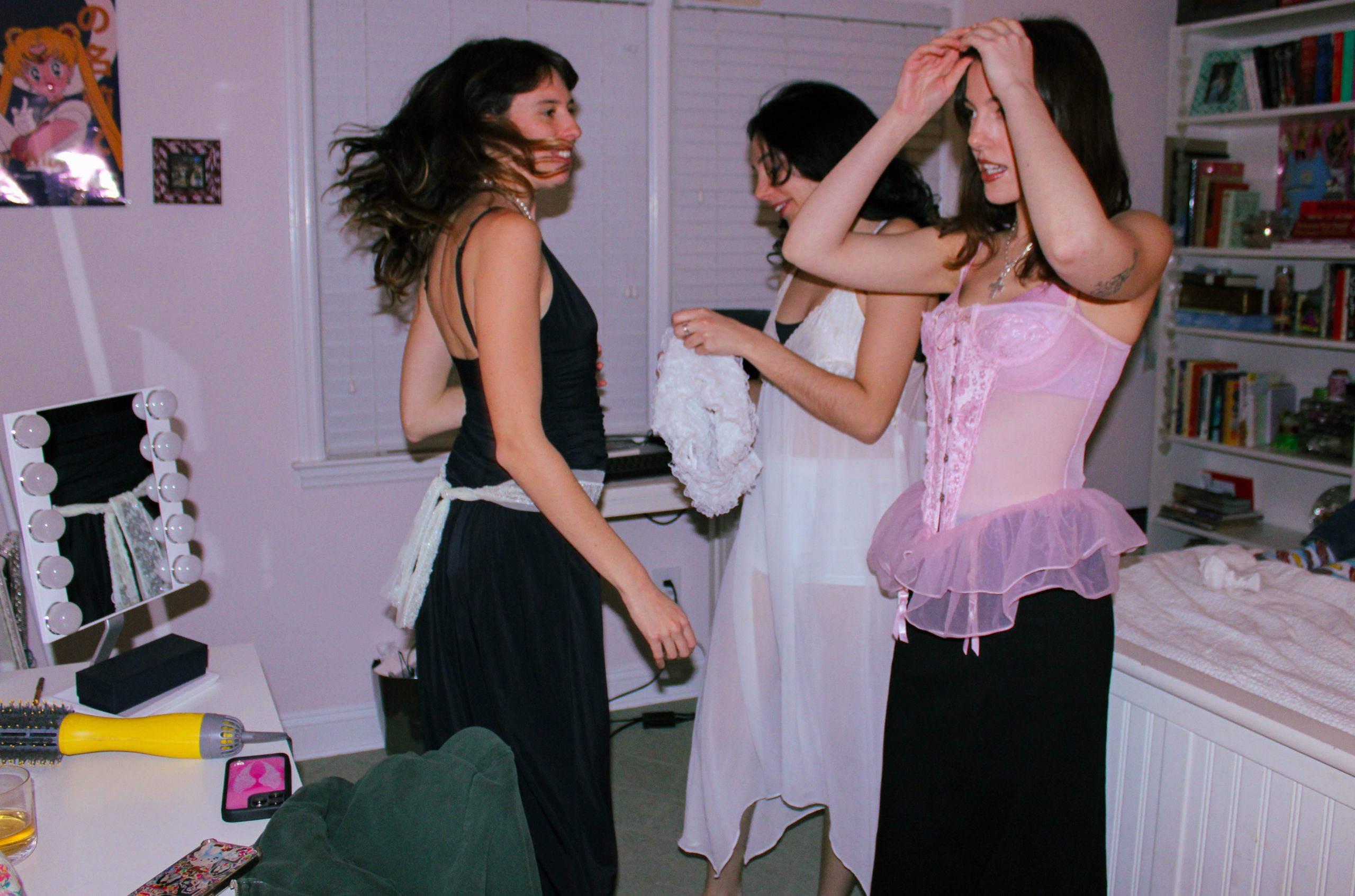 3 models playing dress in front of the mirror