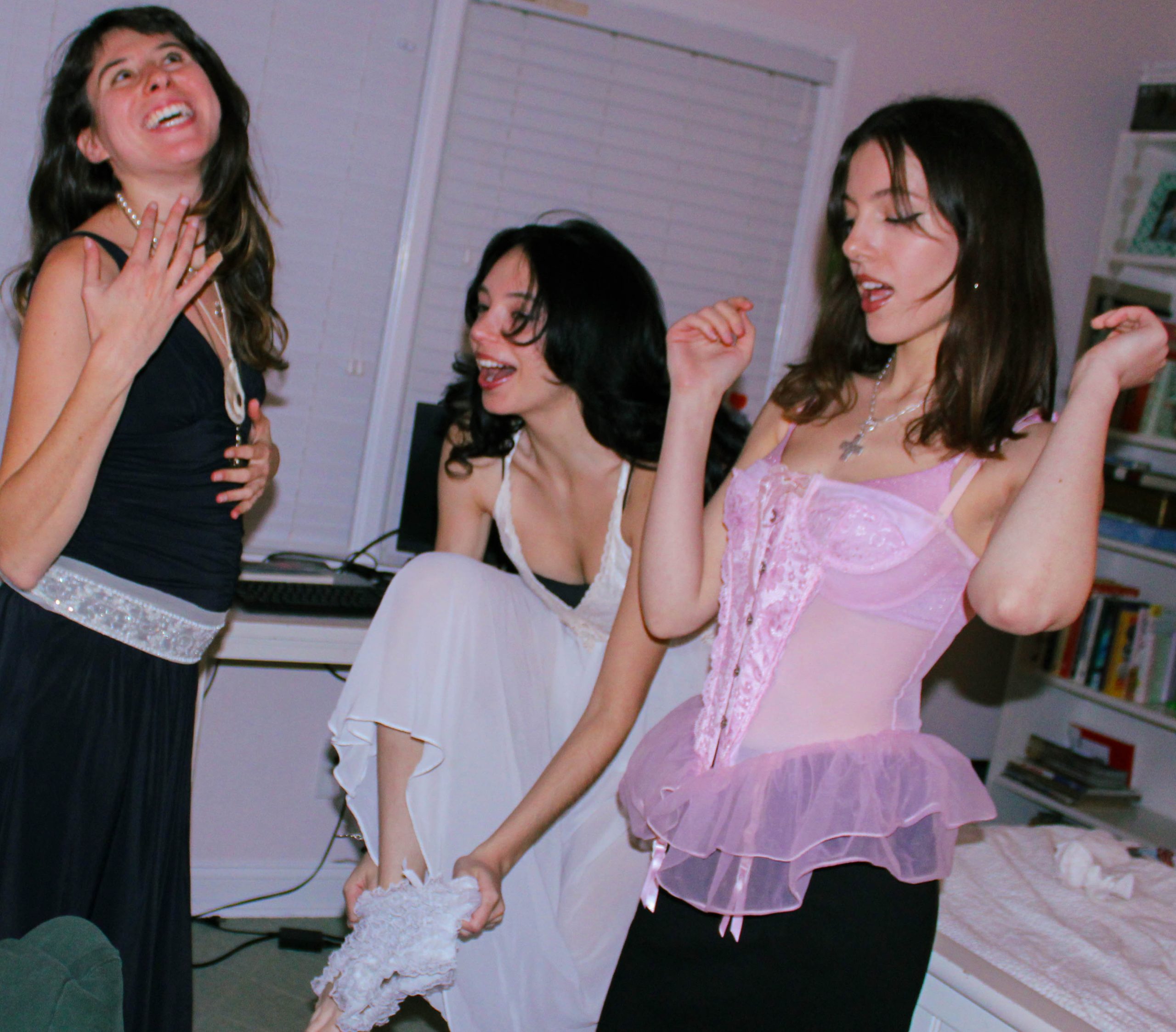 3 models playing dress in front of the mirror