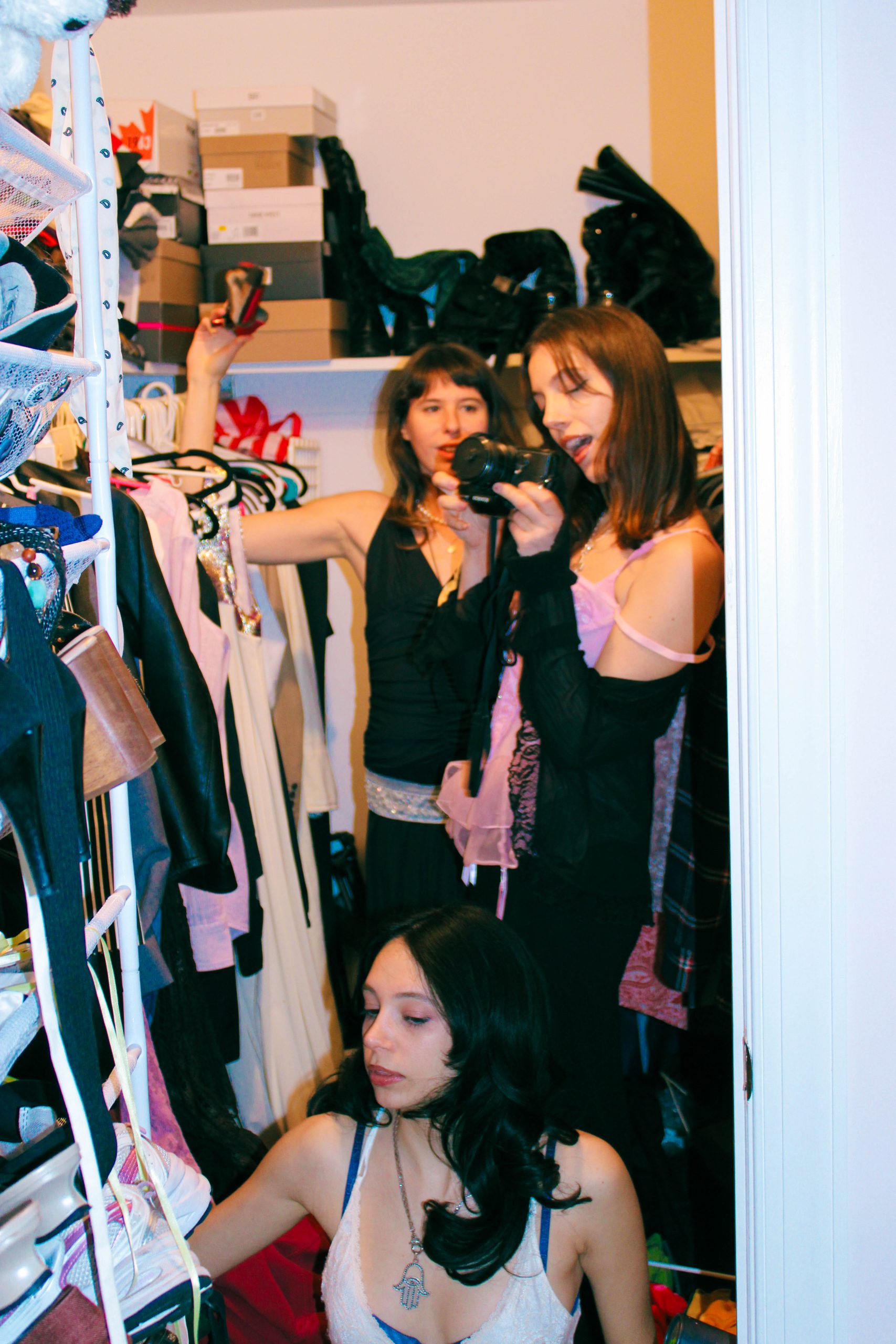 3 models playing dress up in a closet