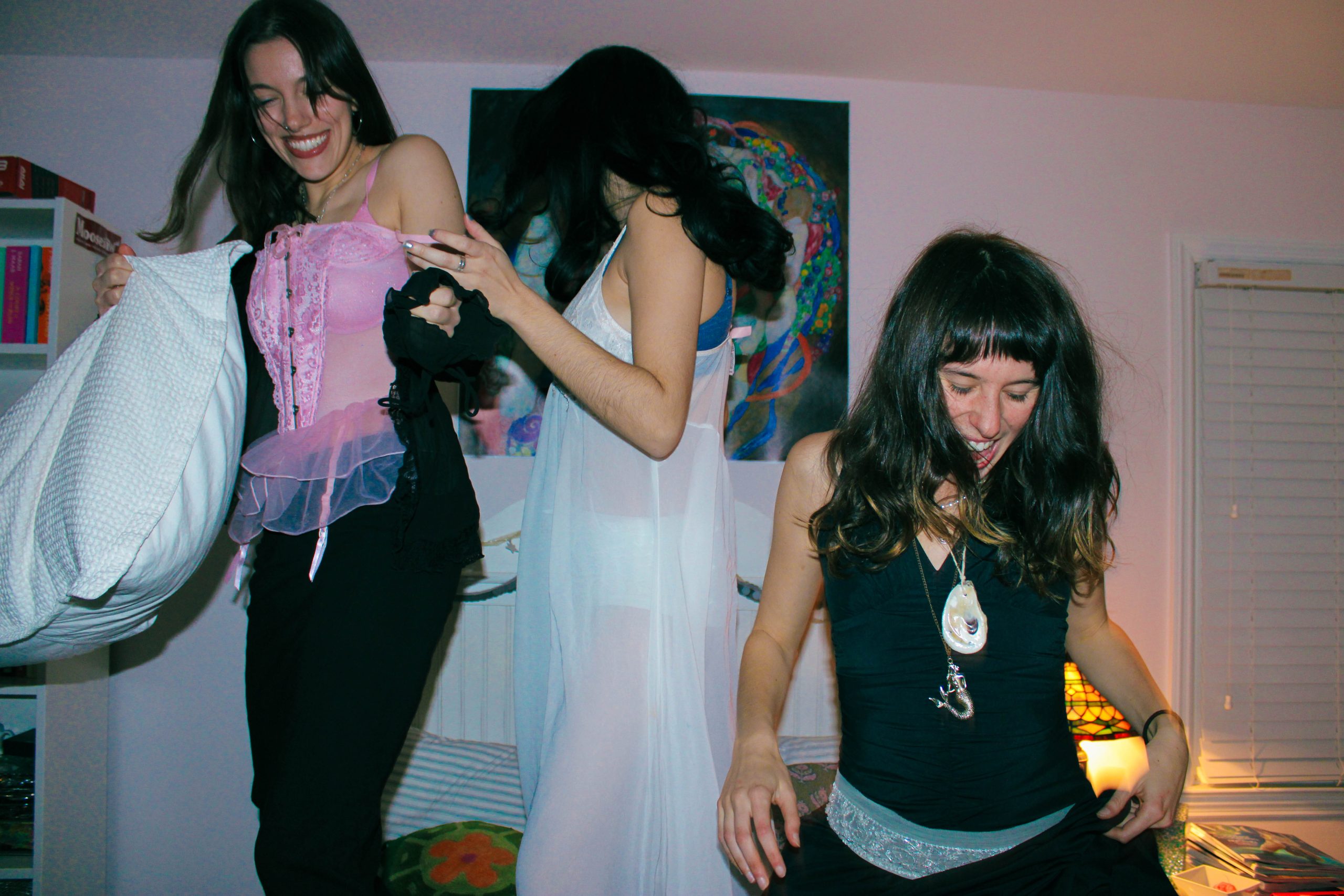 3 models having a pillow fight